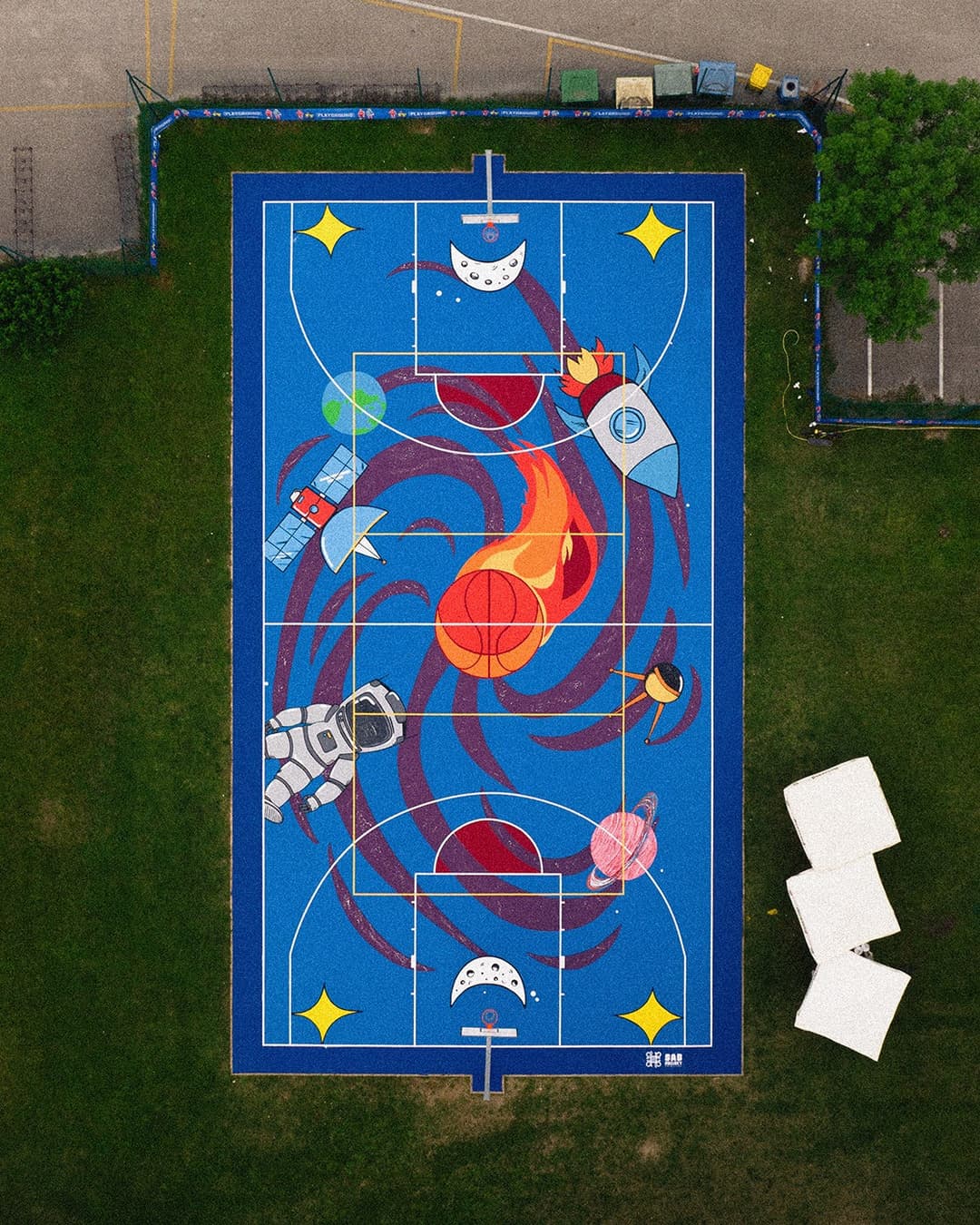 Aerial view of a space-themed painted basketball court